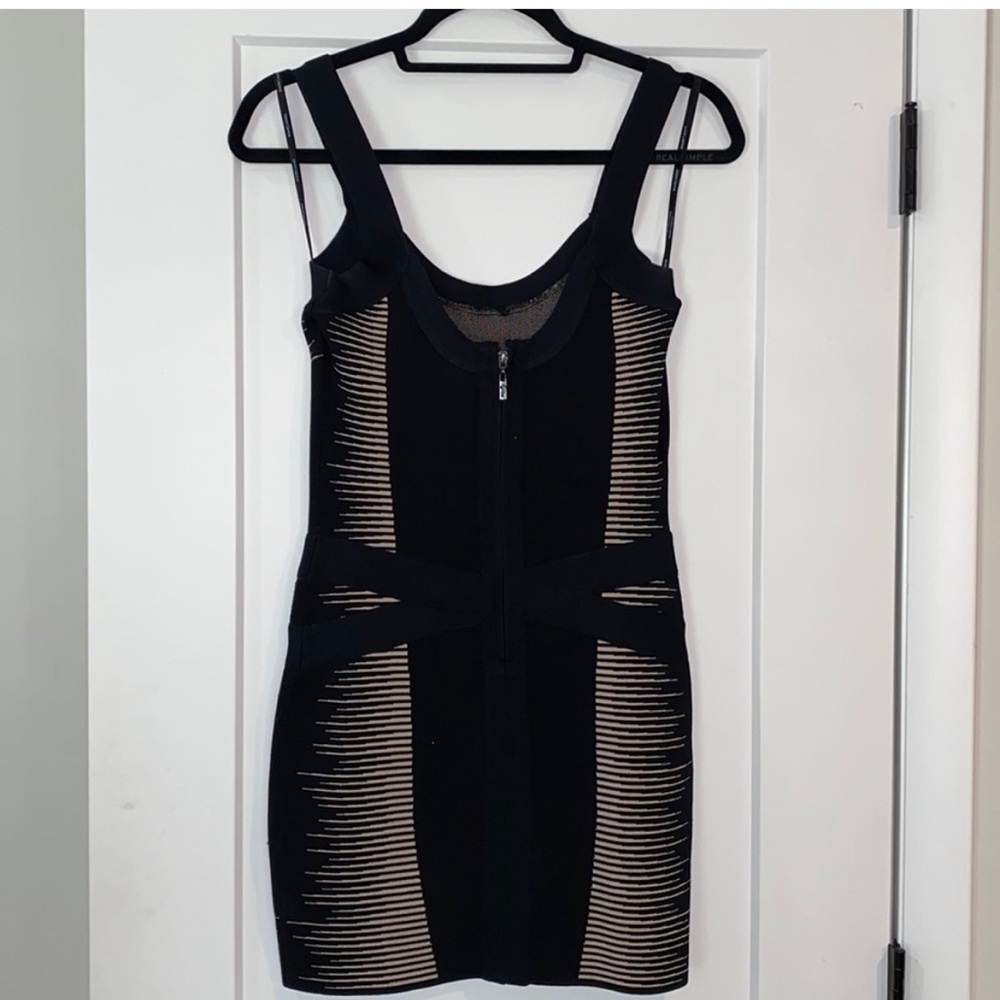 Beautiful little black body con dress with a touch of flair.